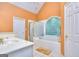 Bright bathroom featuring a tub with glass block window, shower, and a white vanity at 1090 Crown River Pkwy, Mcdonough, GA 30252