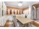 Bright dining room with elegant chandelier, wine racks, and seating for six at 1090 Crown River Pkwy, Mcdonough, GA 30252