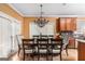 This dining room has a chandelier, hardwood floors, and large windows at 1090 Crown River Pkwy, Mcdonough, GA 30252