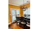 Cozy dining room featuring an elegant chandelier and natural light from french doors at 1090 Crown River Pkwy, Mcdonough, GA 30252
