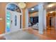 Elegant foyer featuring hardwood floors, a decorative chandelier, and open floor plan at 1090 Crown River Pkwy, Mcdonough, GA 30252