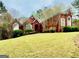 Beautiful brick home with a well-manicured lawn and charming architectural details at 1090 Crown River Pkwy, Mcdonough, GA 30252