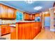 The kitchen features wood cabinets, a breakfast bar, a tile backsplash, and hardwood floors at 1090 Crown River Pkwy, Mcdonough, GA 30252