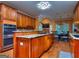 Spacious kitchen features wood cabinets, double ovens, granite counters and a large center island at 1090 Crown River Pkwy, Mcdonough, GA 30252