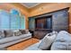 Comfortable living room with wooden entertainment center, plush sofa, and natural light at 1090 Crown River Pkwy, Mcdonough, GA 30252