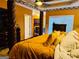 Warm bedroom featuring a four poster bed, tray ceilings, and neutral furniture at 1090 Crown River Pkwy, Mcdonough, GA 30252