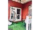 Cozy patio with brick walls, egg-shaped hanging chairs, and astroturf at 1090 Crown River Pkwy, Mcdonough, GA 30252
