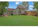 A spacious backyard with a deck, lush lawn, and privacy-enhancing trees surrounding the property at 1952 Skidmore Cir, Lawrenceville, GA 30044