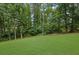 A grassy backyard lined by trees, providing a lush outdoor space at 1952 Skidmore Cir, Lawrenceville, GA 30044