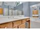 This bathroom features a double sink vanity, and wood cabinets at 1952 Skidmore Cir, Lawrenceville, GA 30044
