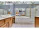 This bathroom features a soaking tub, shower, and wood cabinets at 1952 Skidmore Cir, Lawrenceville, GA 30044