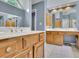 This bathroom features dual sinks and a view of the bedroom at 1952 Skidmore Cir, Lawrenceville, GA 30044