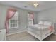 Charming bedroom with ample natural light and a decorative chandelier adds elegance at 1952 Skidmore Cir, Lawrenceville, GA 30044