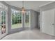 Bright dining room with large windows, a chandelier, and access to an outdoor patio at 1952 Skidmore Cir, Lawrenceville, GA 30044