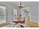 Cozy dining room with white chairs, hardwood floors, and lots of natural light at 1952 Skidmore Cir, Lawrenceville, GA 30044