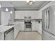 Modern kitchen featuring white cabinets, stainless steel appliances, and stylish backsplash at 1952 Skidmore Cir, Lawrenceville, GA 30044
