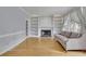 Bright living room featuring hardwood floors, built-in shelving, and a cozy fireplace at 1952 Skidmore Cir, Lawrenceville, GA 30044