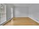 A view of the living room showcasing hardwood floors and two windows at 1952 Skidmore Cir, Lawrenceville, GA 30044