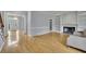 Spacious living room featuring hardwood floors, a fireplace, and an open entryway at 1952 Skidmore Cir, Lawrenceville, GA 30044