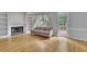 Cozy living room with hardwood floors, a fireplace, built-in shelving, and natural light at 1952 Skidmore Cir, Lawrenceville, GA 30044
