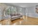 Comfortable living room with hardwood floors, a couch, and large window at 1952 Skidmore Cir, Lawrenceville, GA 30044