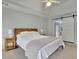The primary bedroom is equipped with a queen bed, ceiling fan, and modern wood-accented headboard at 1952 Skidmore Cir, Lawrenceville, GA 30044