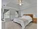 The primary bedroom features tray ceilings, a queen bed, and windows allowing in bright natural light at 1952 Skidmore Cir, Lawrenceville, GA 30044