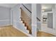 Inviting foyer with hardwood floors, a carpeted staircase, and a glimpse of the bright kitchen at 1952 Skidmore Cir, Lawrenceville, GA 30044
