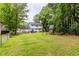 Fenced backyard with mature trees, play set, a stone fire pit and a lush, well-maintained lawn at 2093 Kolb Ridge Sw Ct, Marietta, GA 30008