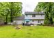 Large, grassy backyard with patio, fire pit, and mature trees provides a private outdoor space at 2093 Kolb Ridge Sw Ct, Marietta, GA 30008