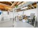Spacious unfinished basement with exposed ceiling joists, painted floor, and bright lighting at 2093 Kolb Ridge Sw Ct, Marietta, GA 30008
