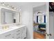 Modern bathroom with double vanity, gold fixtures, and adjacent bedroom access at 2093 Kolb Ridge Sw Ct, Marietta, GA 30008
