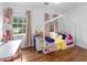 Bright bedroom featuring a decorative bed frame, hardwood floors, and plenty of natural light at 2093 Kolb Ridge Sw Ct, Marietta, GA 30008