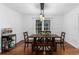 Inviting dining area featuring a wooden table, stylish lighting, and a bright window at 2093 Kolb Ridge Sw Ct, Marietta, GA 30008