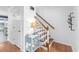 Bright entryway featuring hardwood floors, a staircase with wooden railings, and decorative wall hooks at 2093 Kolb Ridge Sw Ct, Marietta, GA 30008