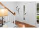 Bright entryway featuring hardwood floors, a staircase with wooden railings, and decorative wall hooks at 2093 Kolb Ridge Sw Ct, Marietta, GA 30008