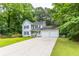 Charming two-story home with white siding, black shutters, a cozy front porch, and an attached two-car garage at 2093 Kolb Ridge Sw Ct, Marietta, GA 30008
