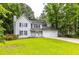 Charming two-story home with white siding, black shutters, a cozy front porch, and an attached two-car garage at 2093 Kolb Ridge Sw Ct, Marietta, GA 30008