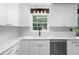 Bright kitchen featuring white cabinets, marble countertops, stainless steel appliances, and modern lighting fixtures at 2093 Kolb Ridge Sw Ct, Marietta, GA 30008