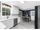 Bright kitchen featuring white cabinets, marble countertops, stainless steel appliances, and modern lighting fixtures at 2093 Kolb Ridge Sw Ct, Marietta, GA 30008
