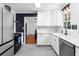 Modern kitchen with white cabinets, stainless steel appliances, and a view into the dining area at 2093 Kolb Ridge Sw Ct, Marietta, GA 30008