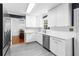 Modern kitchen with white cabinets, stainless steel appliances, and a view into the dining area at 2093 Kolb Ridge Sw Ct, Marietta, GA 30008