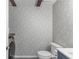 Functional laundry area with modern washer, decorative wallpaper, and overhead cabinets at 2093 Kolb Ridge Sw Ct, Marietta, GA 30008