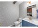 Stylish powder room featuring decorative wallpaper, a modern vanity, and attractive lighting at 2093 Kolb Ridge Sw Ct, Marietta, GA 30008