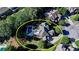 Aerial view of the house showing a pool and backyard oasis with lush landscaping and a patio at 2996 Walkin Horse Trl, Buford, GA 30519