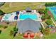 Aerial view of a community pool with waterslides, tennis courts, and playground at 2996 Walkin Horse Trl, Buford, GA 30519