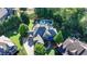 Aerial view of house with nice landscaping, large driveway, and stone and siding exterior at 2996 Walkin Horse Trl, Buford, GA 30519