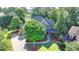 Aerial view of a landscaped home with driveway and beautiful trees at 2996 Walkin Horse Trl, Buford, GA 30519
