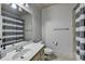 Bathroom with a white vanity and mirror, toilet, and a gray-striped shower curtain at 2996 Walkin Horse Trl, Buford, GA 30519