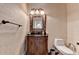 Charming bathroom with a vintage vanity, mirror, and toilet with patterned wallpaper at 2996 Walkin Horse Trl, Buford, GA 30519
